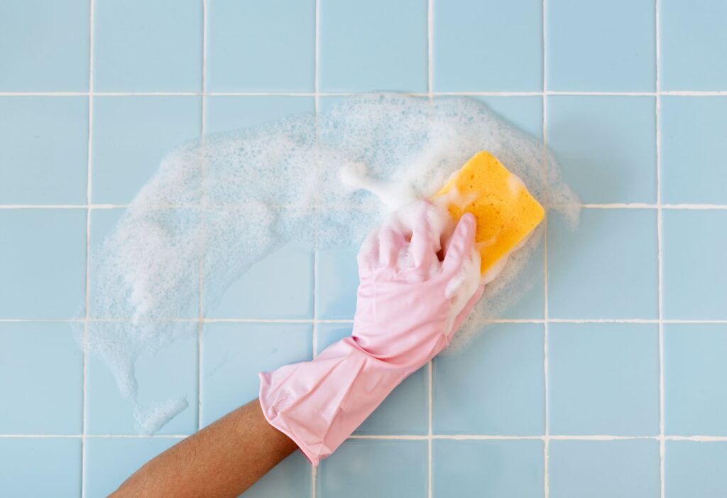 The Right Way to Clean Bathroom Tiles: A Sparkling Step-by-Step Guide 12 a person's hand cleaning bathroom tile